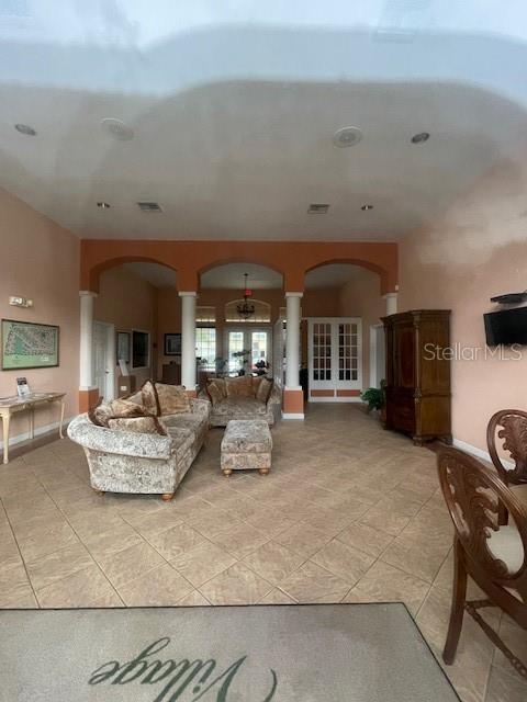 tiled living room with ornate columns