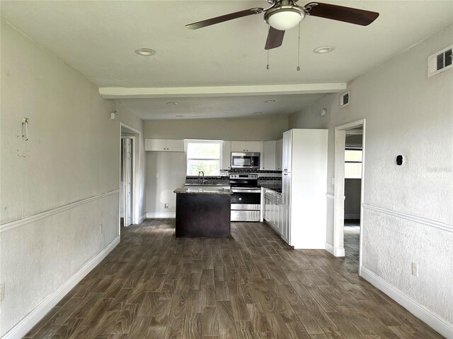 kitchen with a center island, white cabinetry, dark hardwood / wood-style floors, and stainless steel appliances