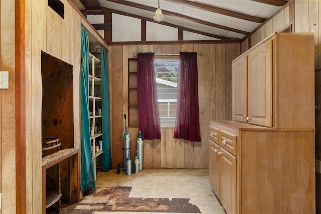 interior space with lofted ceiling with beams and wood walls