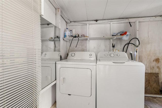 clothes washing area with independent washer and dryer