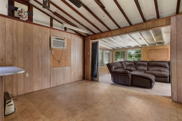 living room with vaulted ceiling with beams, wooden walls, and a wall unit AC