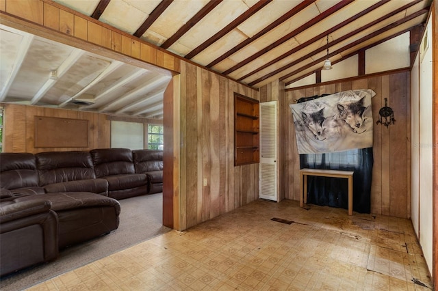 living room with lofted ceiling with beams and wood walls