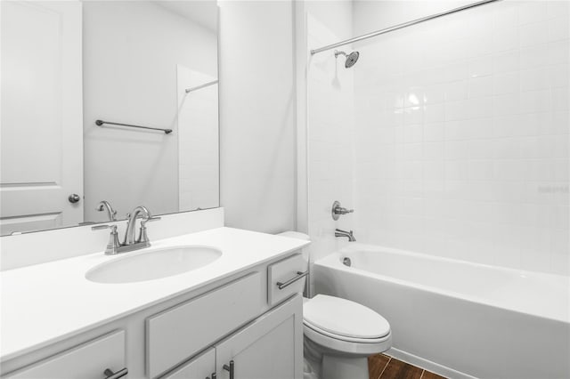 full bathroom with tub / shower combination, hardwood / wood-style floors, toilet, and vanity