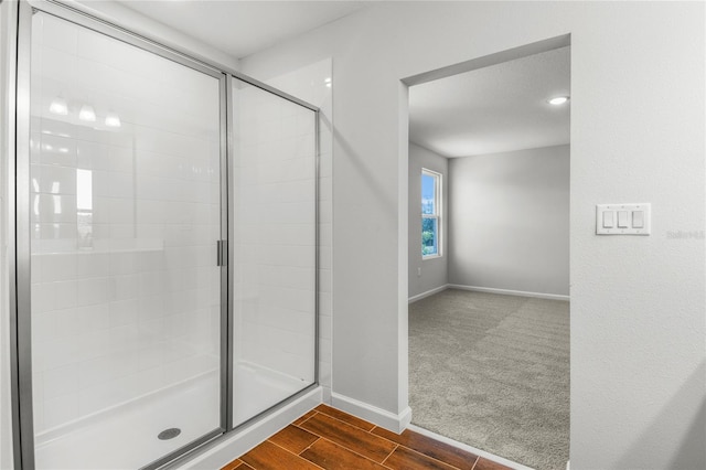 bathroom featuring a shower with shower door