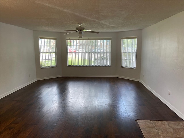 unfurnished room featuring a textured ceiling, ceiling fan, and dark wood-type flooring