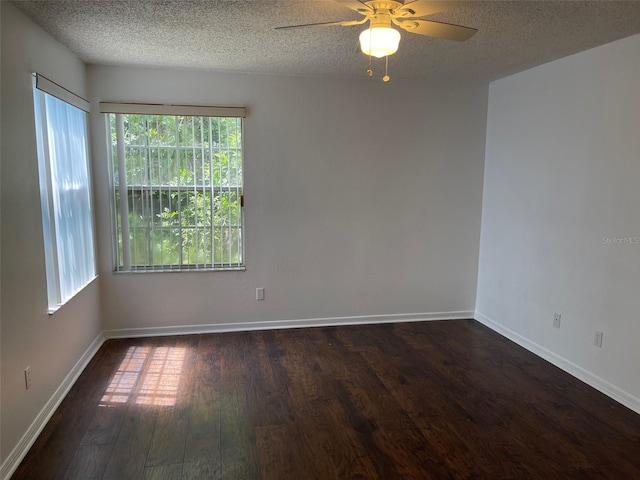 spare room featuring ceiling fan, dark hardwood / wood-style floors, and a textured ceiling