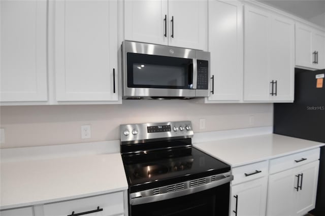 kitchen featuring white cabinets and appliances with stainless steel finishes