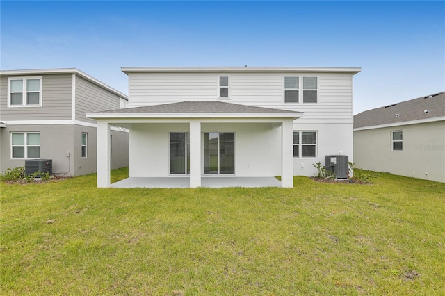 back of property featuring central AC, a patio, and a lawn