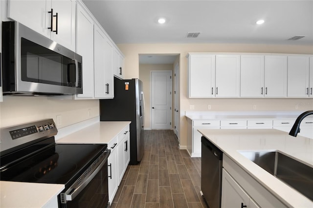 kitchen with white cabinetry, appliances with stainless steel finishes, and sink