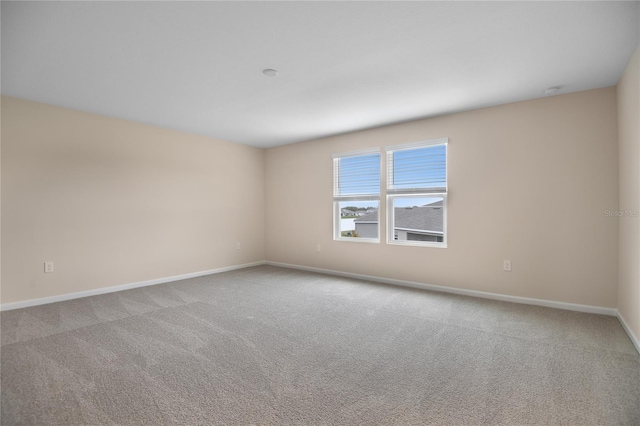 unfurnished room with light colored carpet