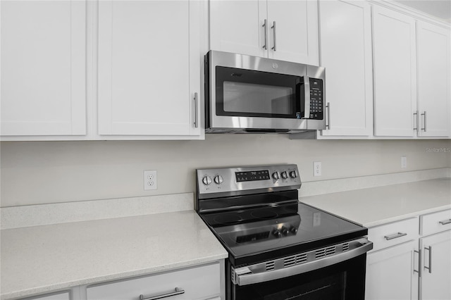 kitchen featuring white cabinets and appliances with stainless steel finishes