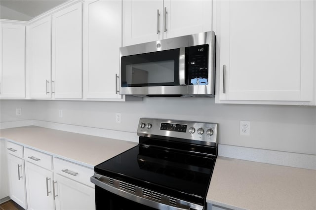 kitchen featuring white cabinets and appliances with stainless steel finishes