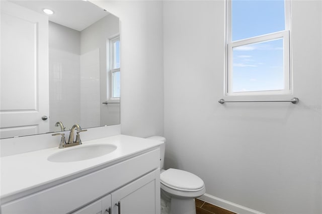 bathroom featuring toilet and vanity