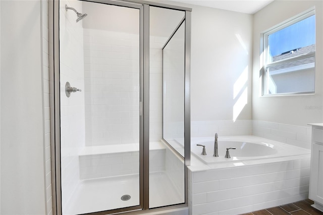 bathroom with vanity and shower with separate bathtub