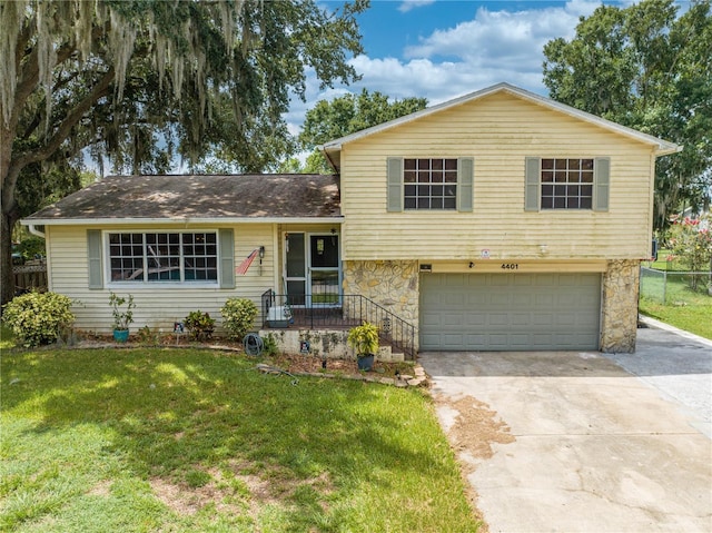 split level home with a garage and a front yard