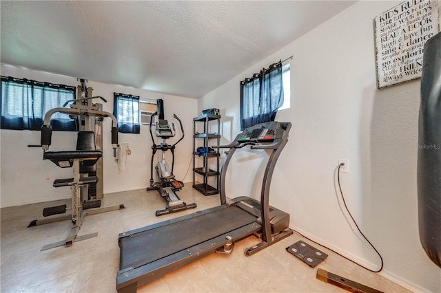 workout area featuring a textured ceiling