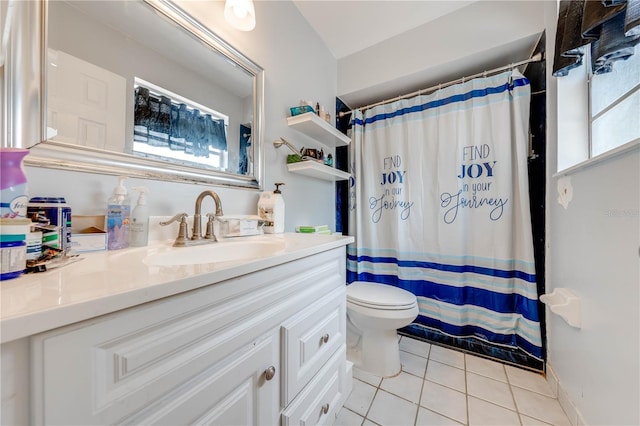 bathroom featuring vanity, tile patterned floors, toilet, and plenty of natural light