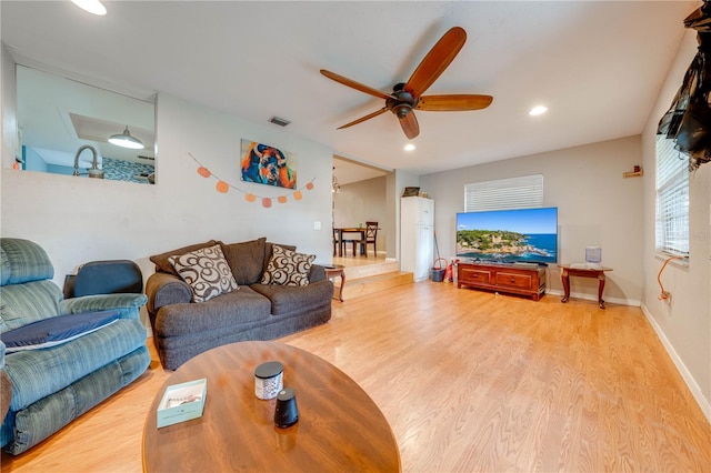 living room with ceiling fan and hardwood / wood-style floors