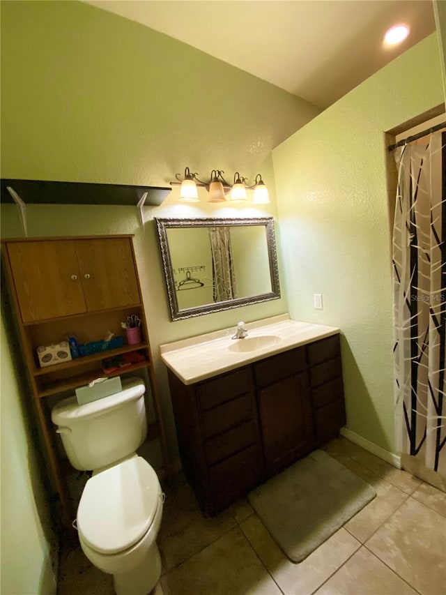 bathroom featuring vanity, tile patterned flooring, and toilet