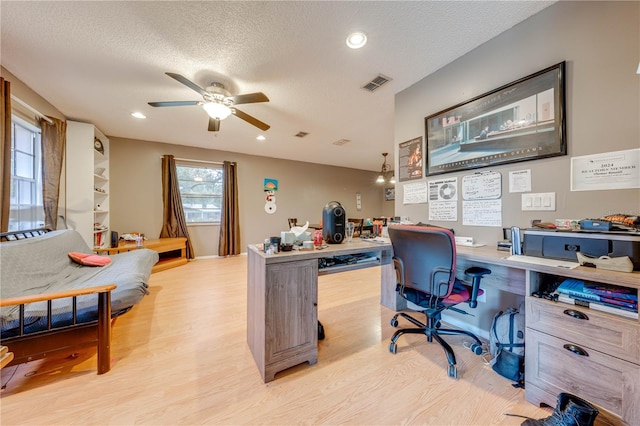 home office featuring ceiling fan, a textured ceiling, and light hardwood / wood-style flooring