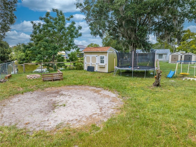 view of yard with a trampoline and a storage unit