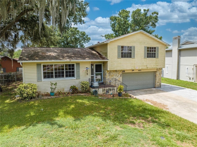 tri-level home with a garage and a front yard