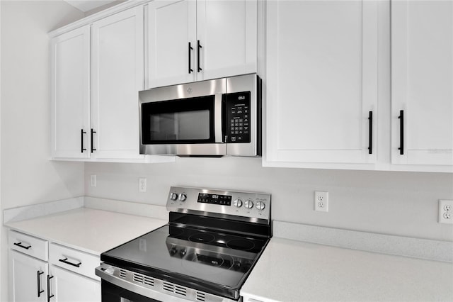 kitchen featuring appliances with stainless steel finishes and white cabinets