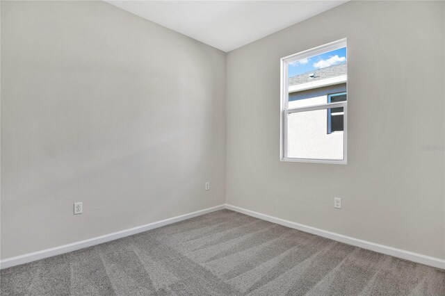 carpeted empty room featuring plenty of natural light