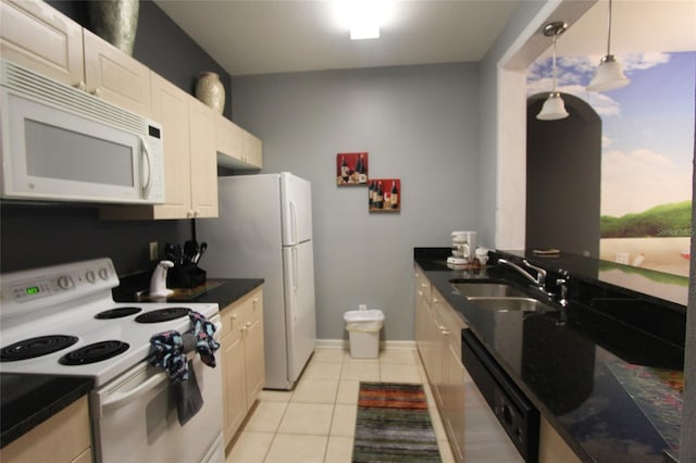 kitchen featuring light tile patterned floors, pendant lighting, white appliances, and sink