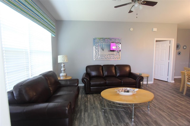 living room with ceiling fan and dark wood-type flooring