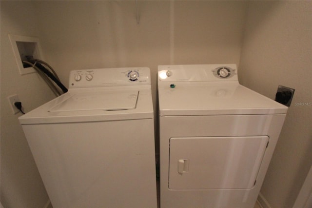 clothes washing area with washer and clothes dryer