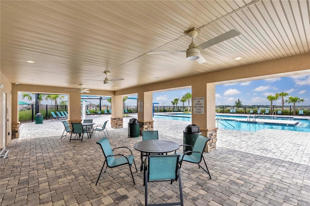 view of patio featuring a community pool and ceiling fan