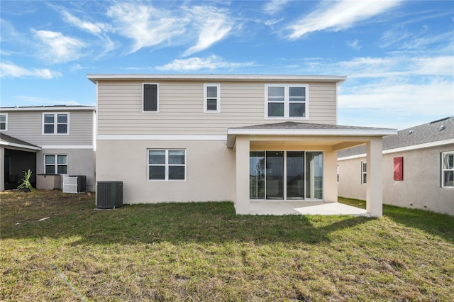 rear view of property featuring a patio, a yard, and central AC unit