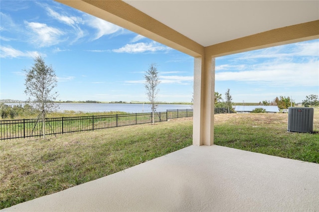 view of patio featuring a water view and cooling unit