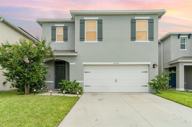 6728 Huntleigh Hammock Rd, Harmony, FL 34773 - traditional-style home with stucco siding, an attached garage, a front lawn, and concrete driveway