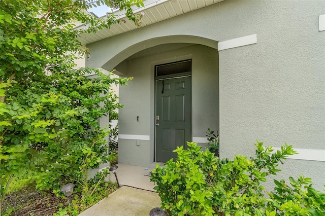 6728 Huntleigh Hammock Rd, Harmony, FL 34773 - doorway to property with stucco siding