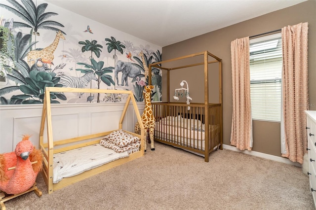 bedroom with a crib and light colored carpet