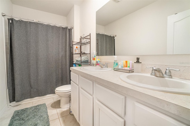 bathroom with toilet, tile patterned flooring, and double vanity