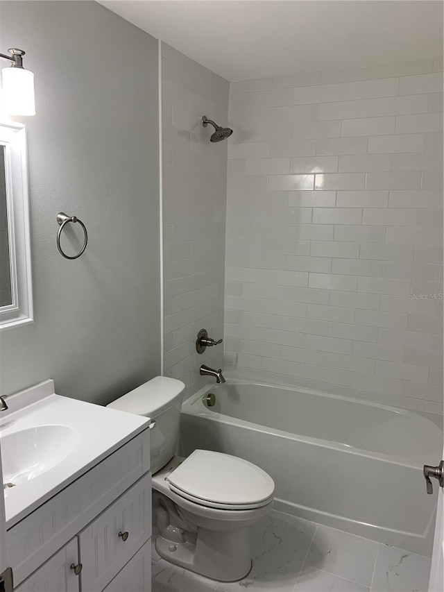 bathroom featuring toilet, marble finish floor, shower / tub combination, and vanity