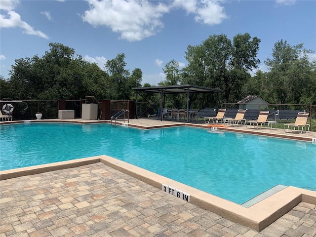 community pool featuring a gazebo, fence, and a patio