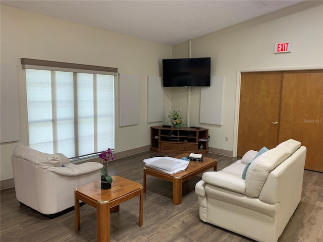 living room featuring wood finished floors and baseboards