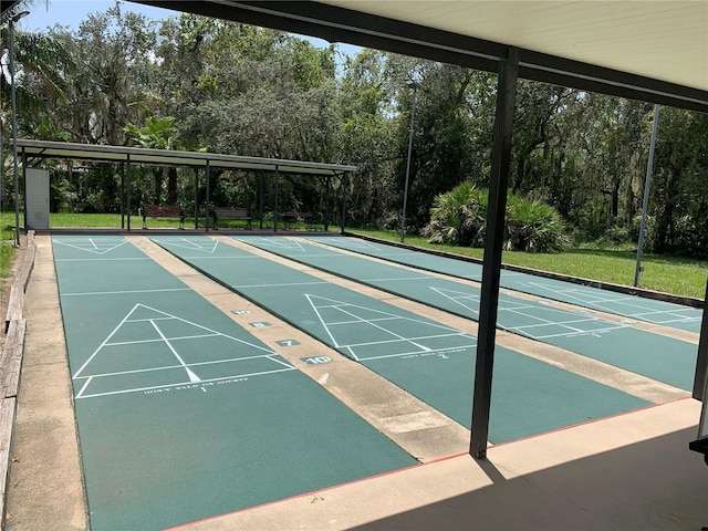 view of community featuring a yard and shuffleboard