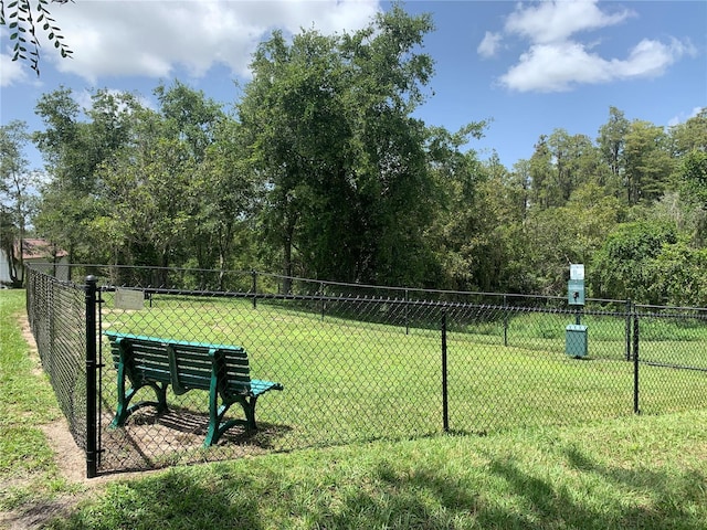 surrounding community with a yard and fence