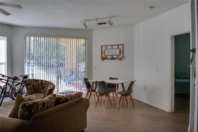 interior space with track lighting, hardwood / wood-style flooring, and ceiling fan