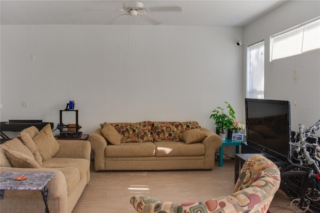 living room featuring light hardwood / wood-style flooring and ceiling fan