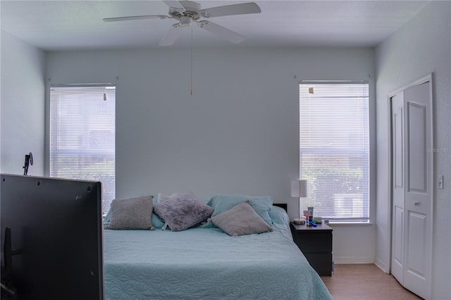 bedroom featuring wood-type flooring and ceiling fan