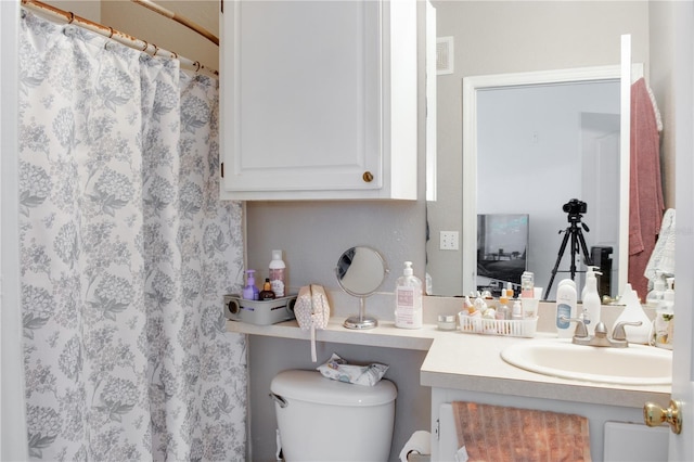 bathroom featuring vanity and toilet