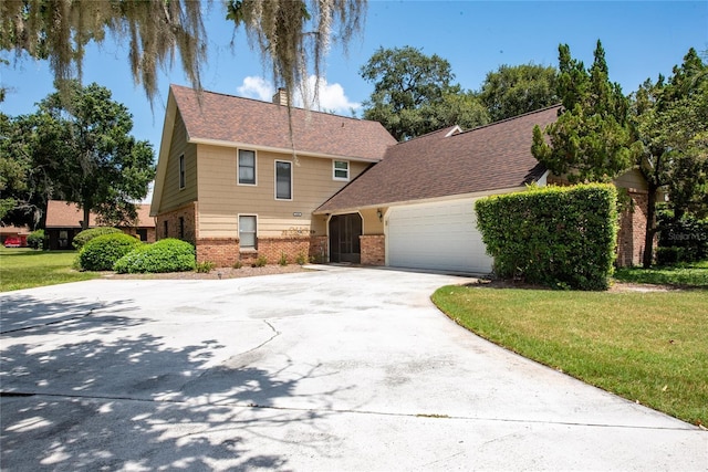 view of front facade with a garage and a front lawn