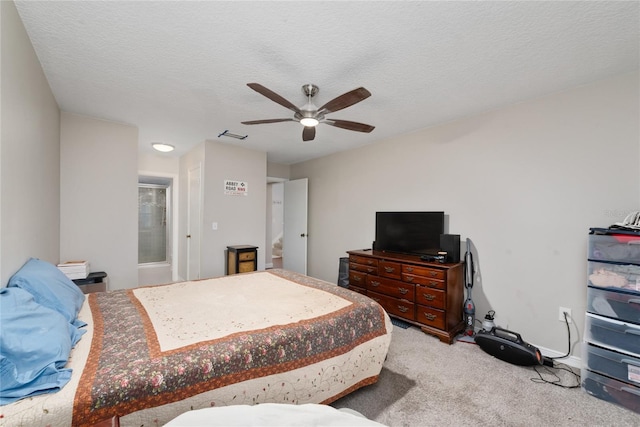 carpeted bedroom with ceiling fan and a textured ceiling