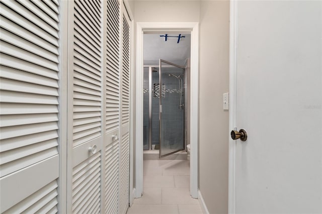 hall featuring light tile patterned flooring